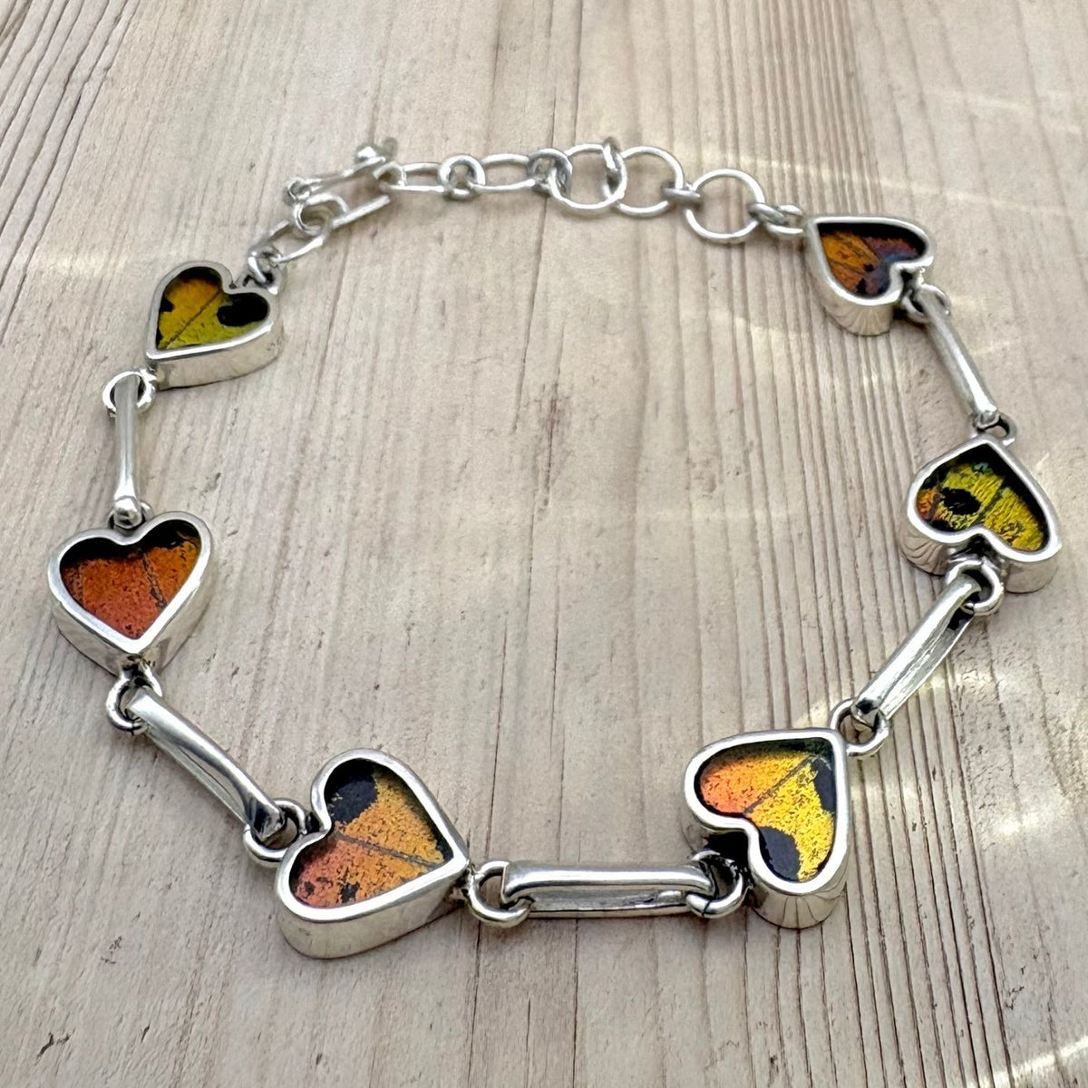 Bracelet Aelya Cœur Ambre ocellé en argent et ailes de papillon