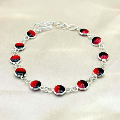 Bracelet Sumaq en argent avec graines naturelles de huayruro. Création artisanale de la collection Héritage.