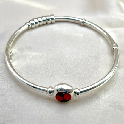 Bracelet jonc en argent avec huayruro naturel vue d’ensemble