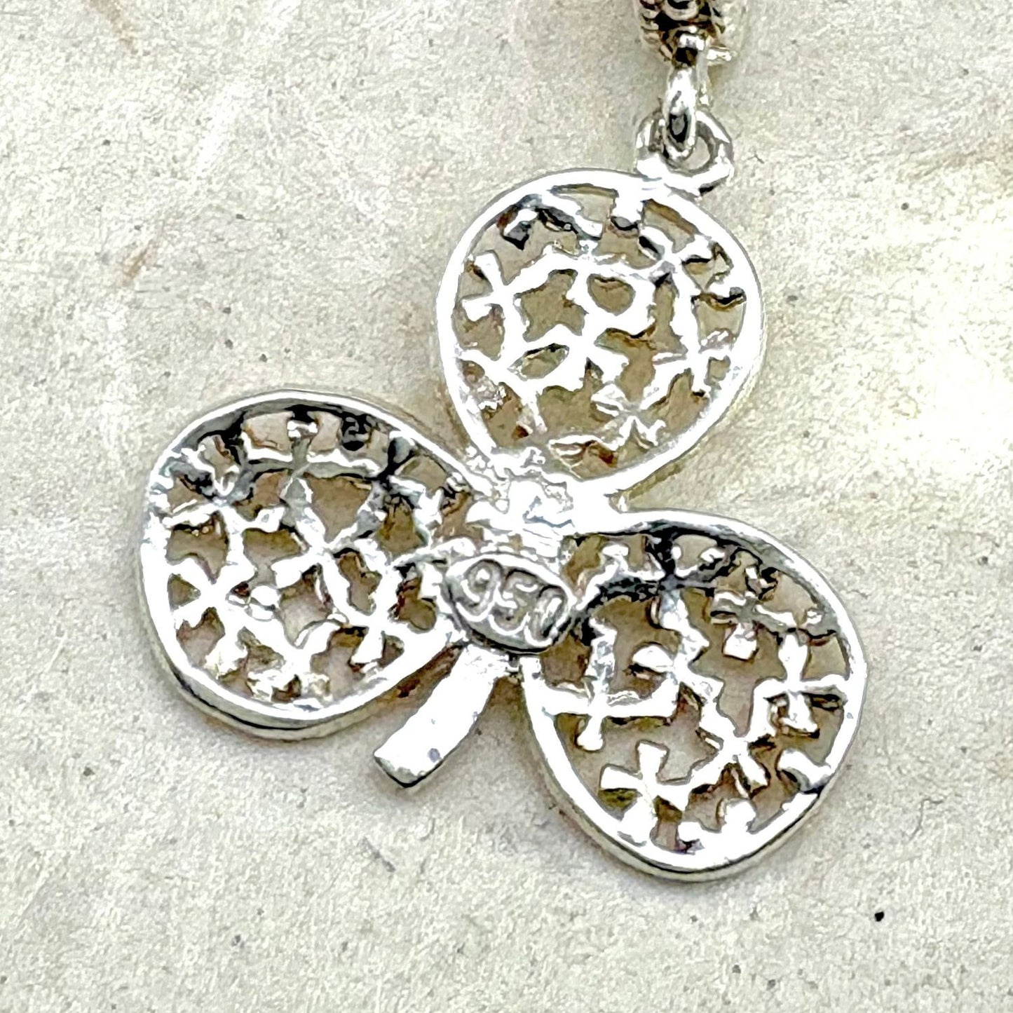 Vue arrière du pendentif Folia révélant les détails de fabrication et le poinçon de l'argent . 